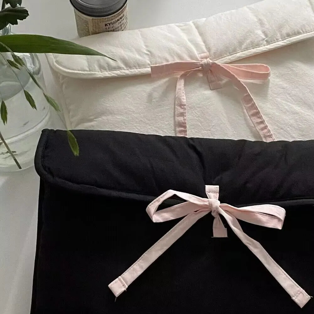 Black and white striped quilted laptop bag with ballet-style bow for women