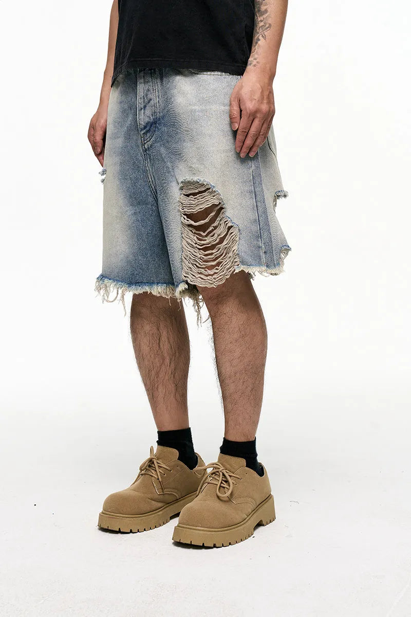 Light blue men's baggy denim shorts with a washed finish and zipper fly on a mid waist.