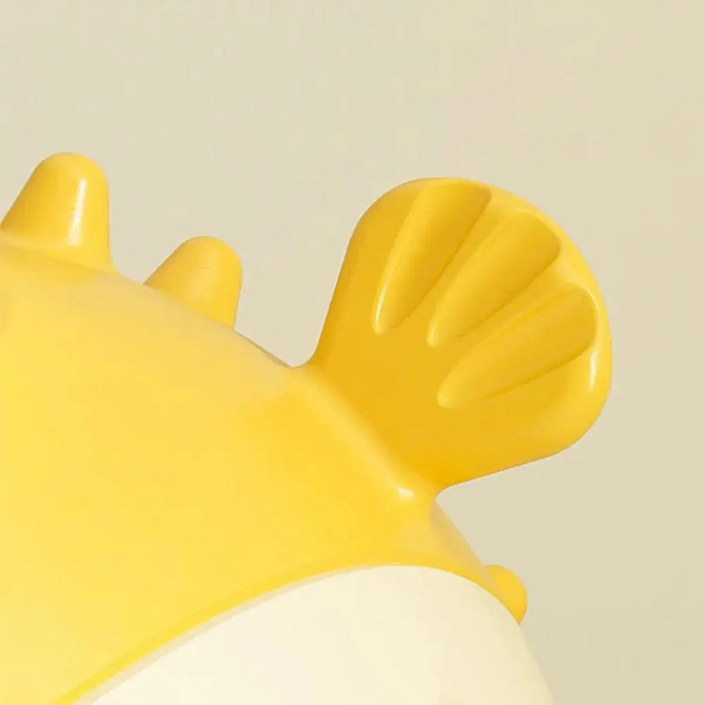Yellow fish-shaped dog chew toy with textured surface and squeaker function