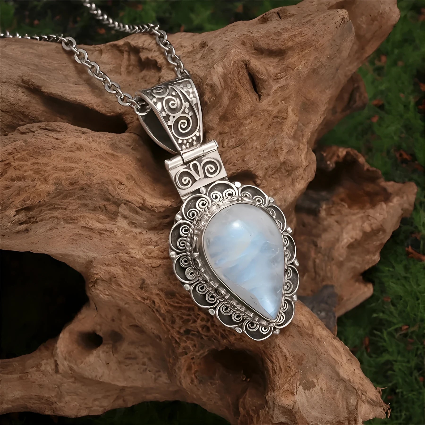Silver heart-shaped moonstone drop necklace on a white background