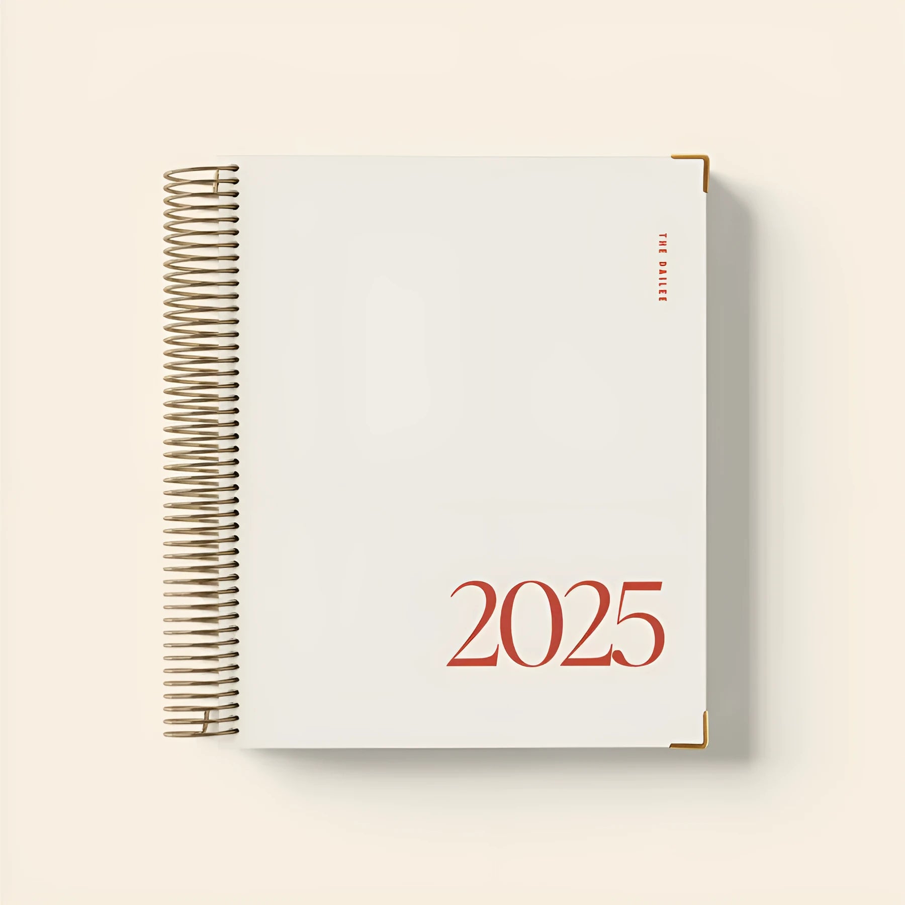 Cherry red A5 daily schedule coil notebook showing spiral binding and open pages