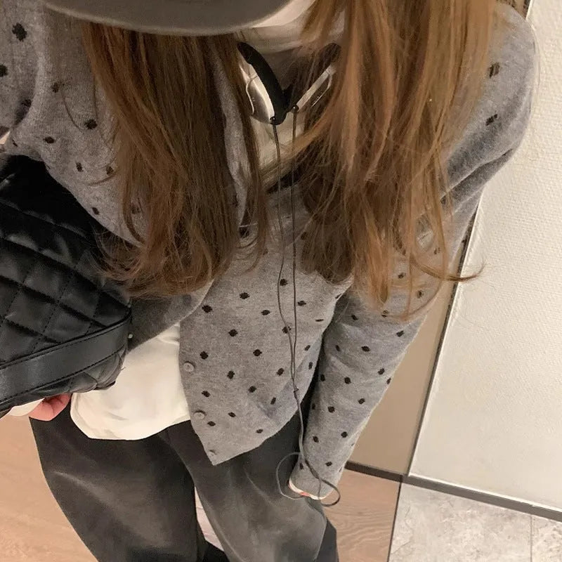 Women's grey dot pattern knitted cardigan with long sleeves and crocheted flower details