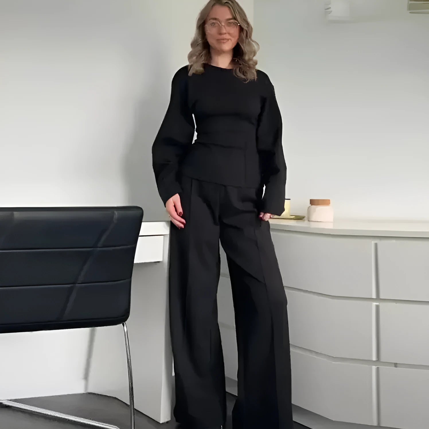Women's black polar fleece suit set with long sleeve top and wide leg trousers