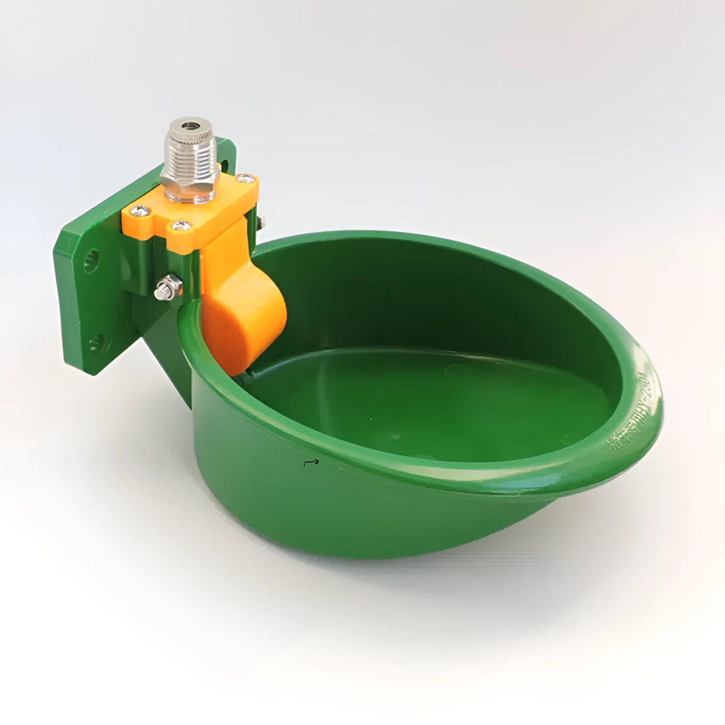 Green plastic livestock drinking bowl for sheep and pigs on farm