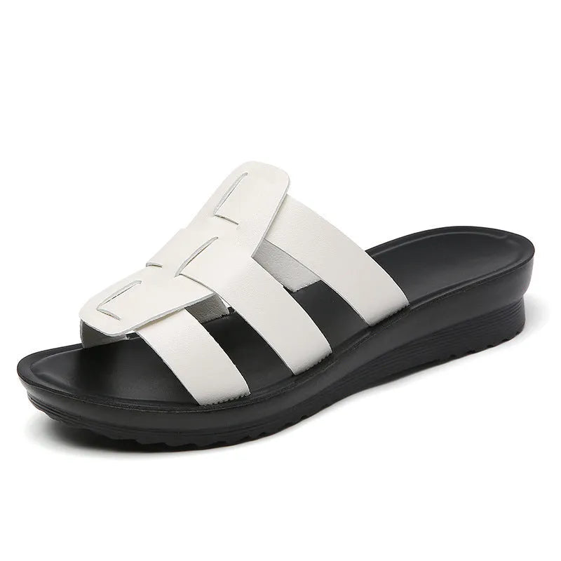 Women's flat bottom slippers in beige, black, or brown waxed PU leather with a viscose interior.