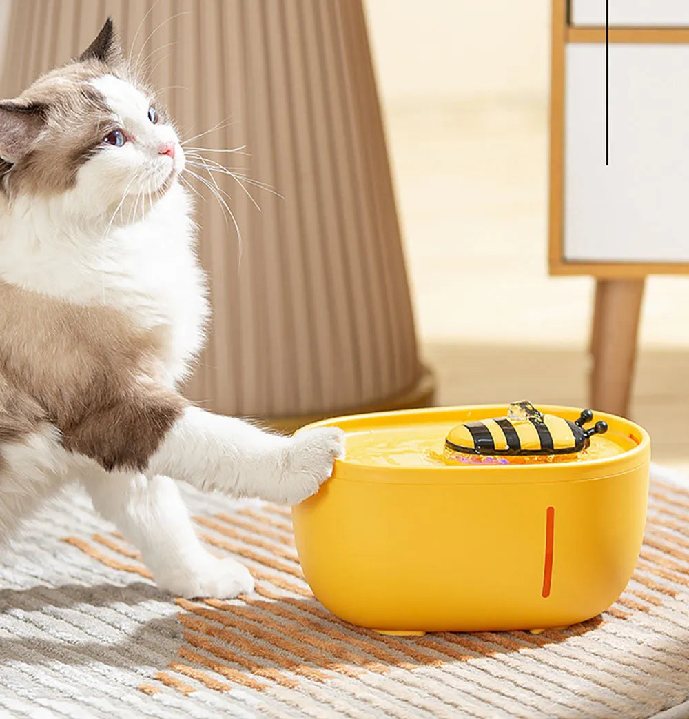 Yellow automatic cat water fountain with filtration system, water level window, and USB cable