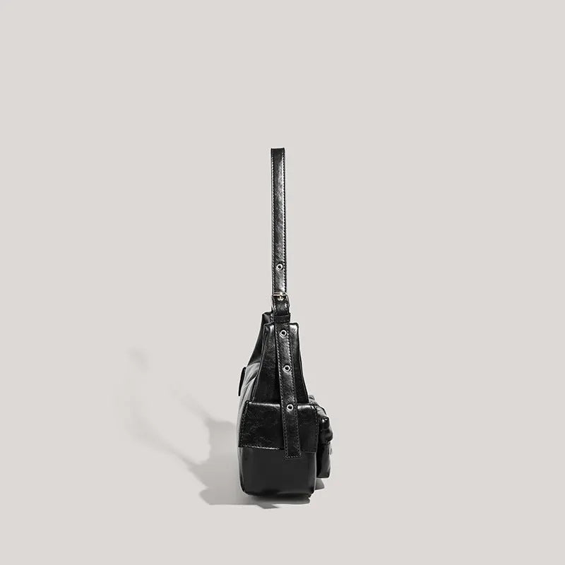 Black PU leather shoulder motorcycle bag with sewing line details against a plain background