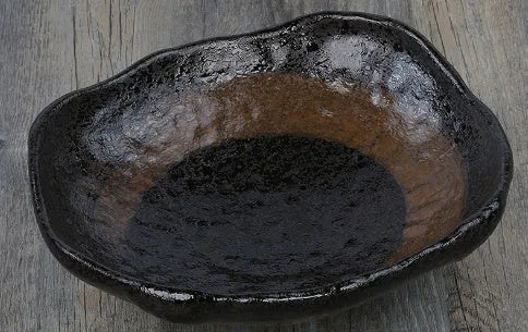 Irregular shaped Japanese coarse pottery bowl with floral decoration measuring 24cm length