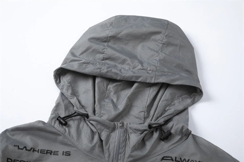Men's nylon sun protection jacket with letters print in gray, shown on a model