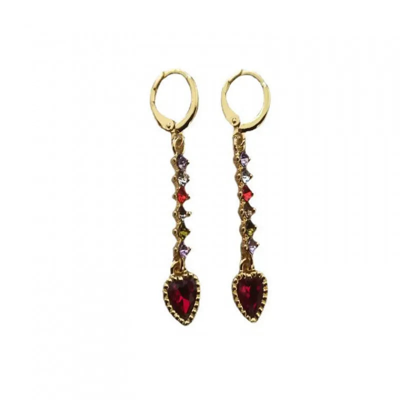 A pair of women's heart-shaped alloy earrings with a shiny electroplated gold finish.