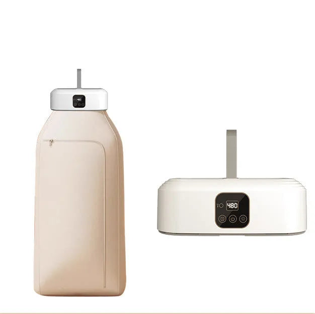 White cylindrical portable laundry drier with remote control on flat surface