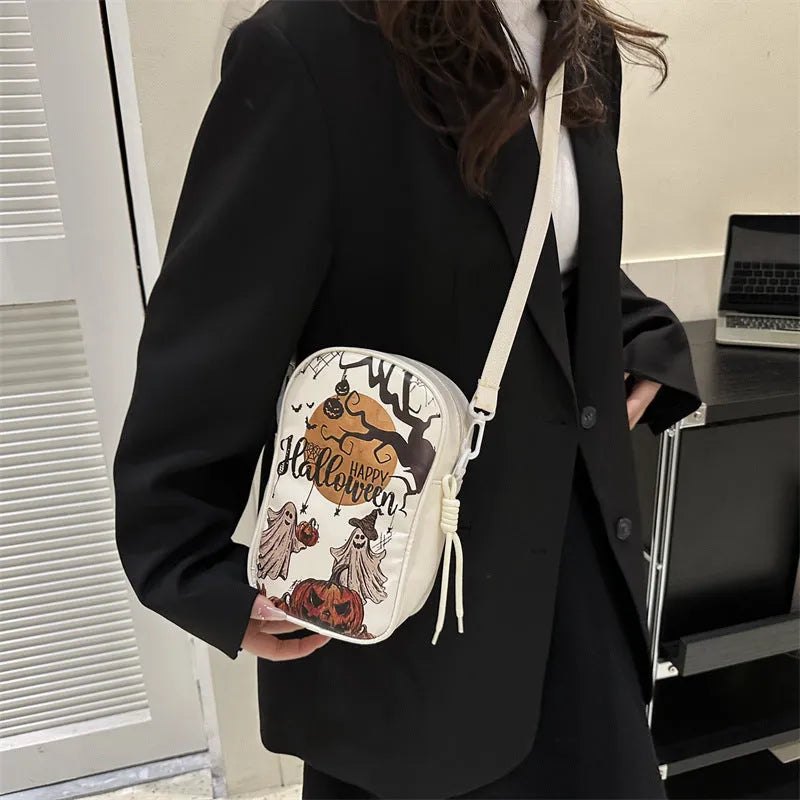 Halloween graffiti print crossbody bag with cartoon pumpkin ghost bat design in orange colour