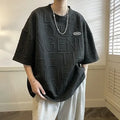 Men's grey short sleeve T-shirt with a raised 3D white letter print in a loose, retro style.