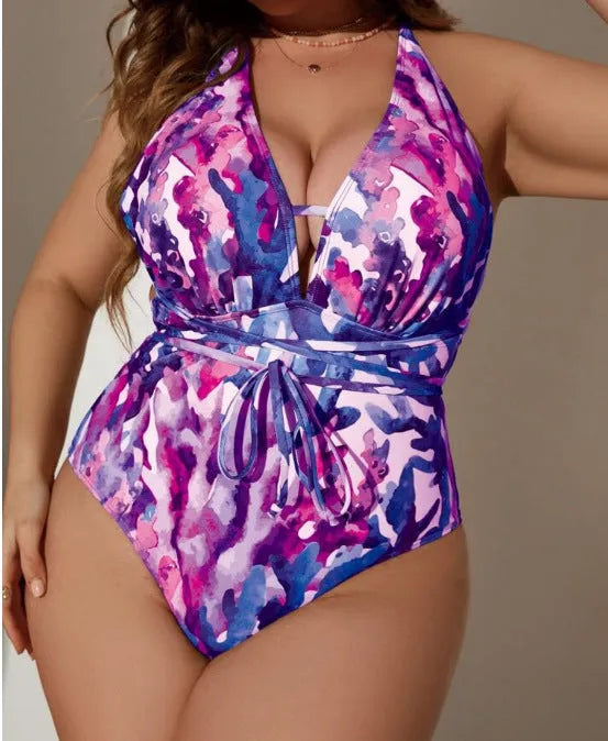 A purple one-piece halter swimsuit for women on a hanger.