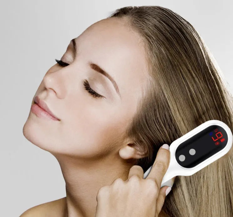 White electric head massager comb with red and blue lights and LED display on scalp