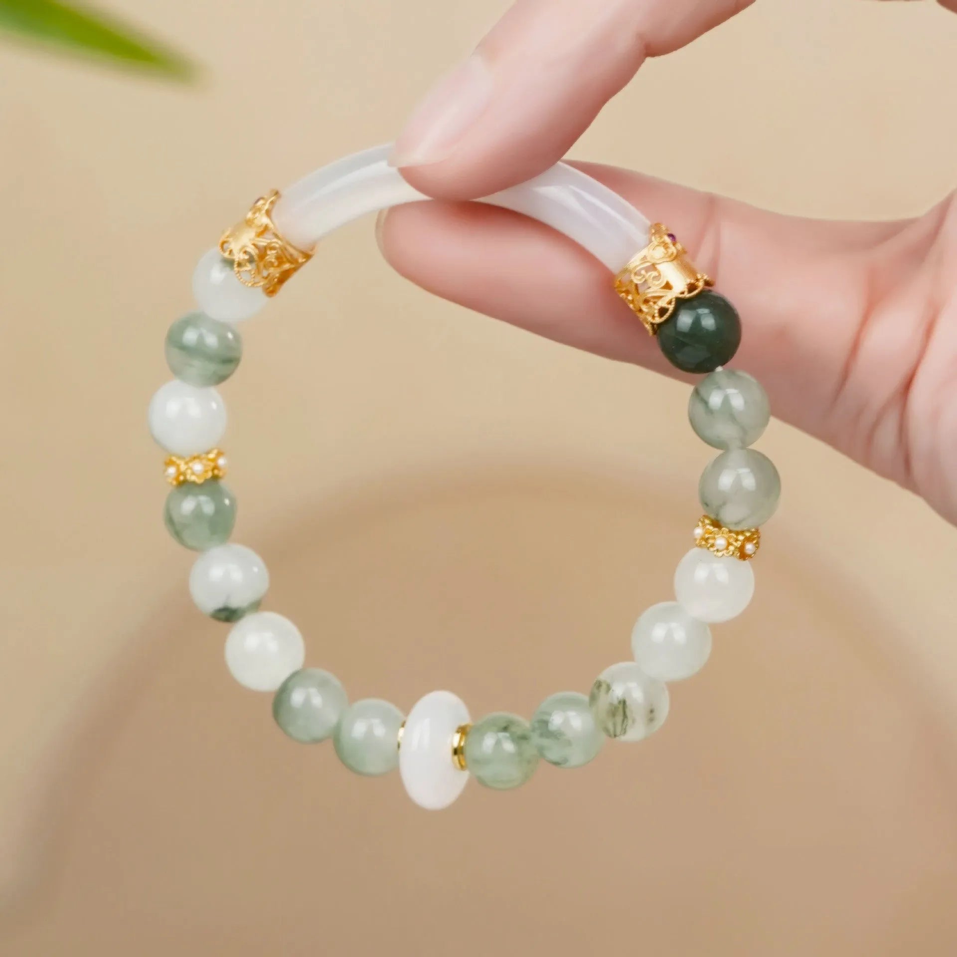 Emerald green jade bangle bracelet with floating flower design and round beads