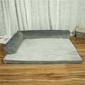 Corduroy pet sofa dog bed with bolster sides, shown in grey colour on a wooden floor