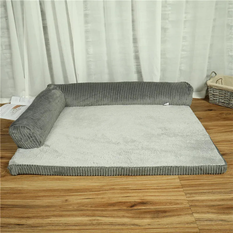 Corduroy pet sofa dog bed with bolster sides, shown in grey colour on a wooden floor