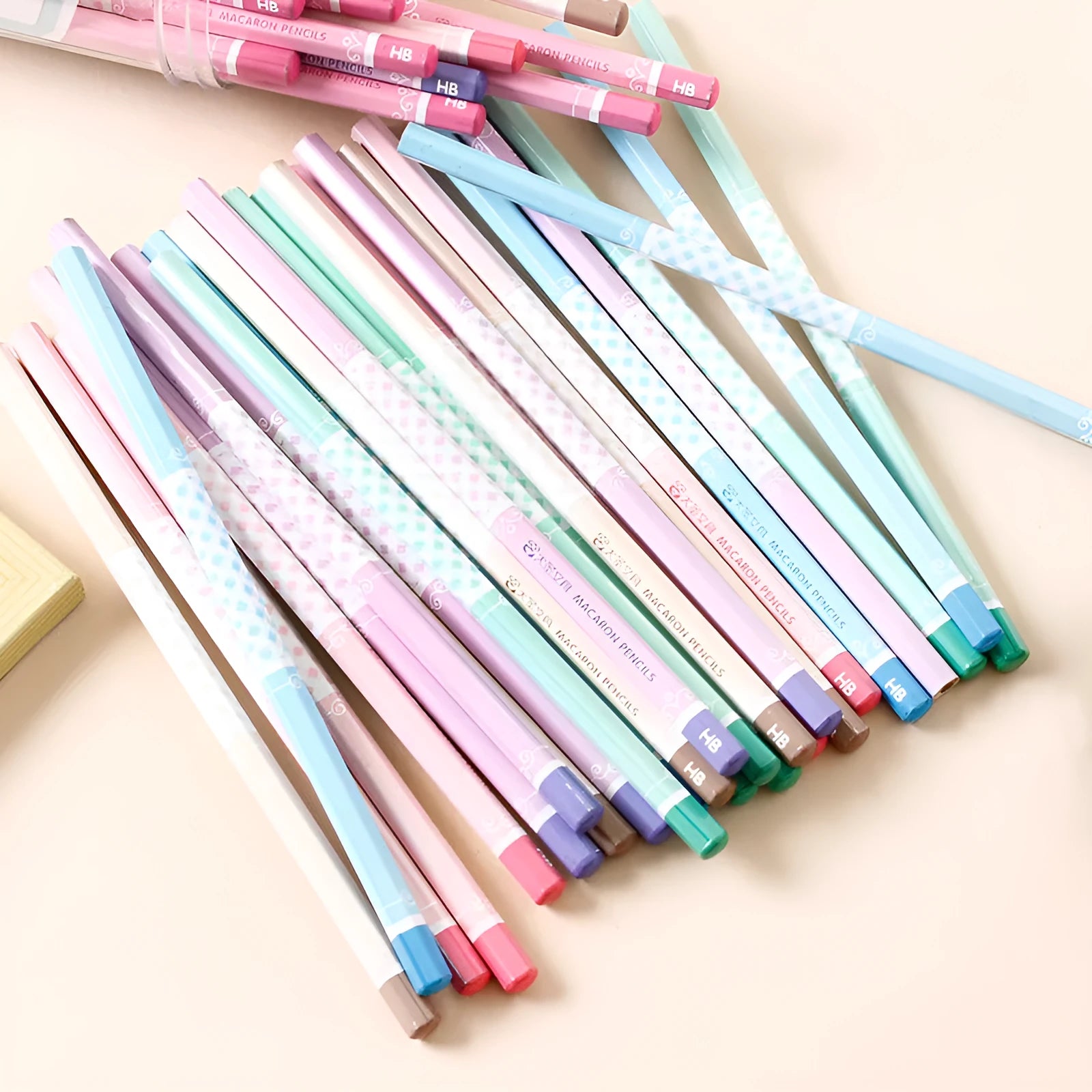 Barrel of 50 basswood six-angle thermal transfer pencils with HB refills on a work surface.