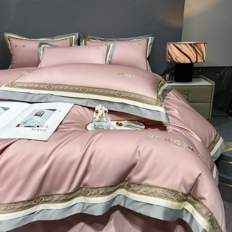 All-cotton light luxury four-piece bedding set with embroidery, available in multiple colours, on a bed
