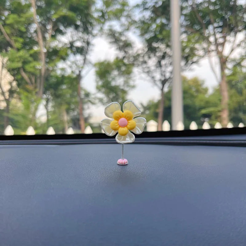 Colourful plastic swing car decoration measuring 5cm tall