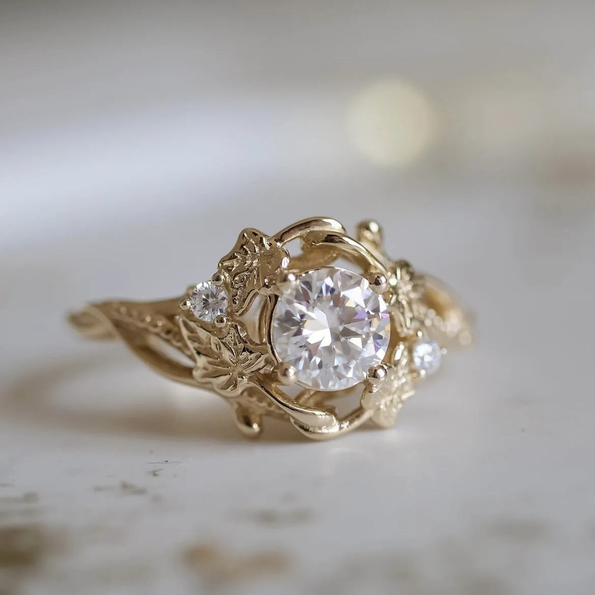 Gold alloy ring with brushed finish on neutral background
