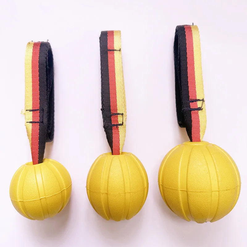 Yellow and camouflage coloured EVA floating dog balls with strings in 6.5cm, 7cm, and 9cm sizes.