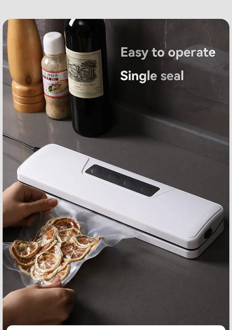 White compact automatic vacuum sealer machine for household food preservation on kitchen counter
