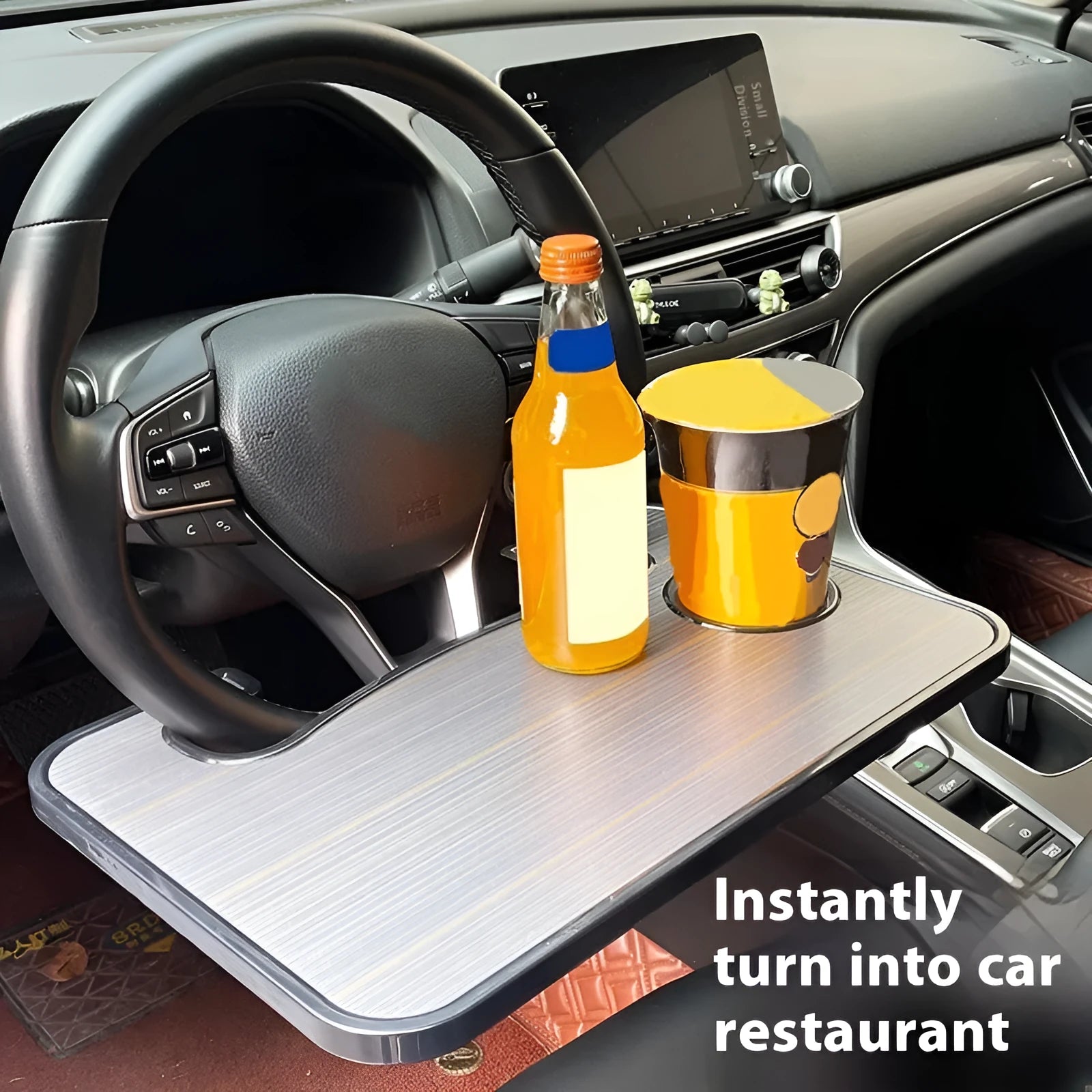 Black car steering wheel laptop tray with foldable cup holder on a 42cm by 28cm surface.