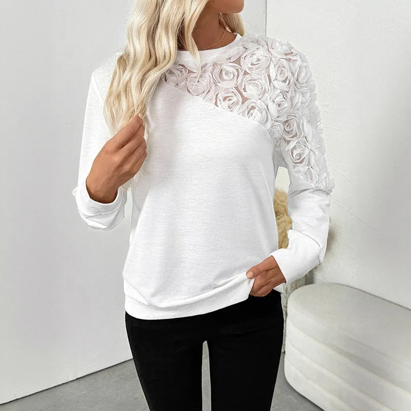 White floral patterned long sleeve women's pullover top with a loose fit.