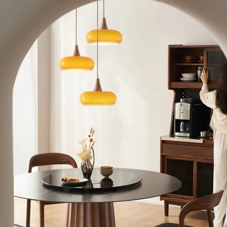Cream style dining room chandelier with glass shade and wood art frame