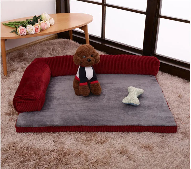 Corduroy pet sofa dog bed with bolster sides, shown in grey colour on a wooden floor