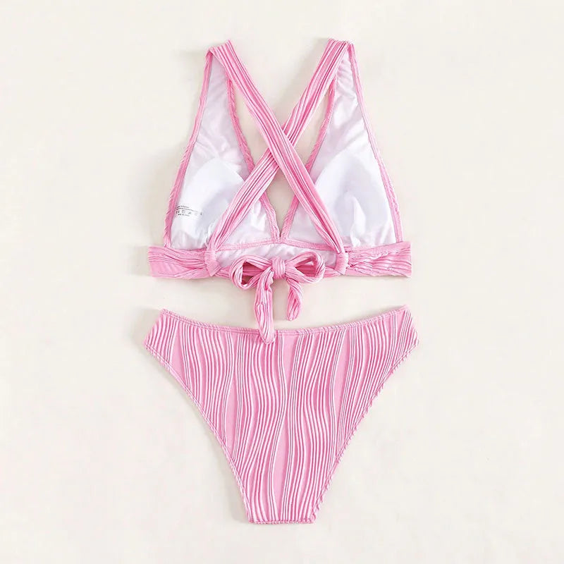 Women's pink and black halter strap bikini top with matching split shorts on a mannequin.