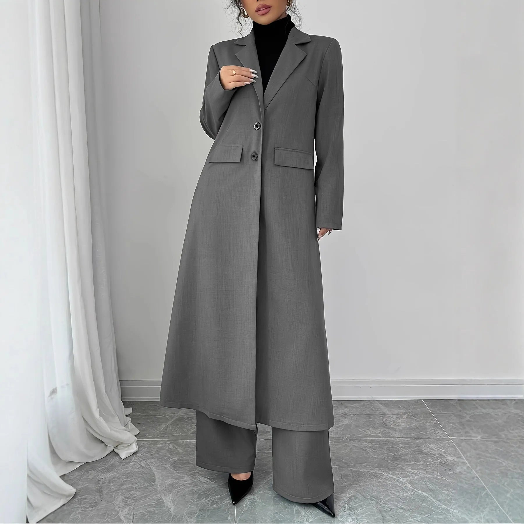 Women's gray polyester two-piece suit with long jacket and trousers on mannequin