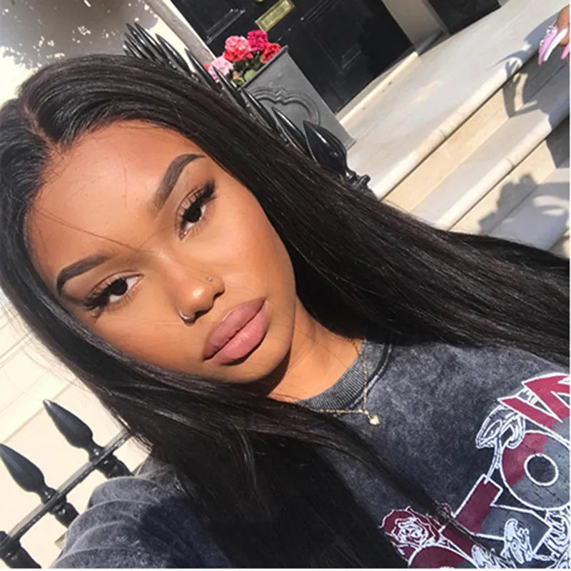 Long straight black synthetic wig with centre-parted bangs on a hair cover.