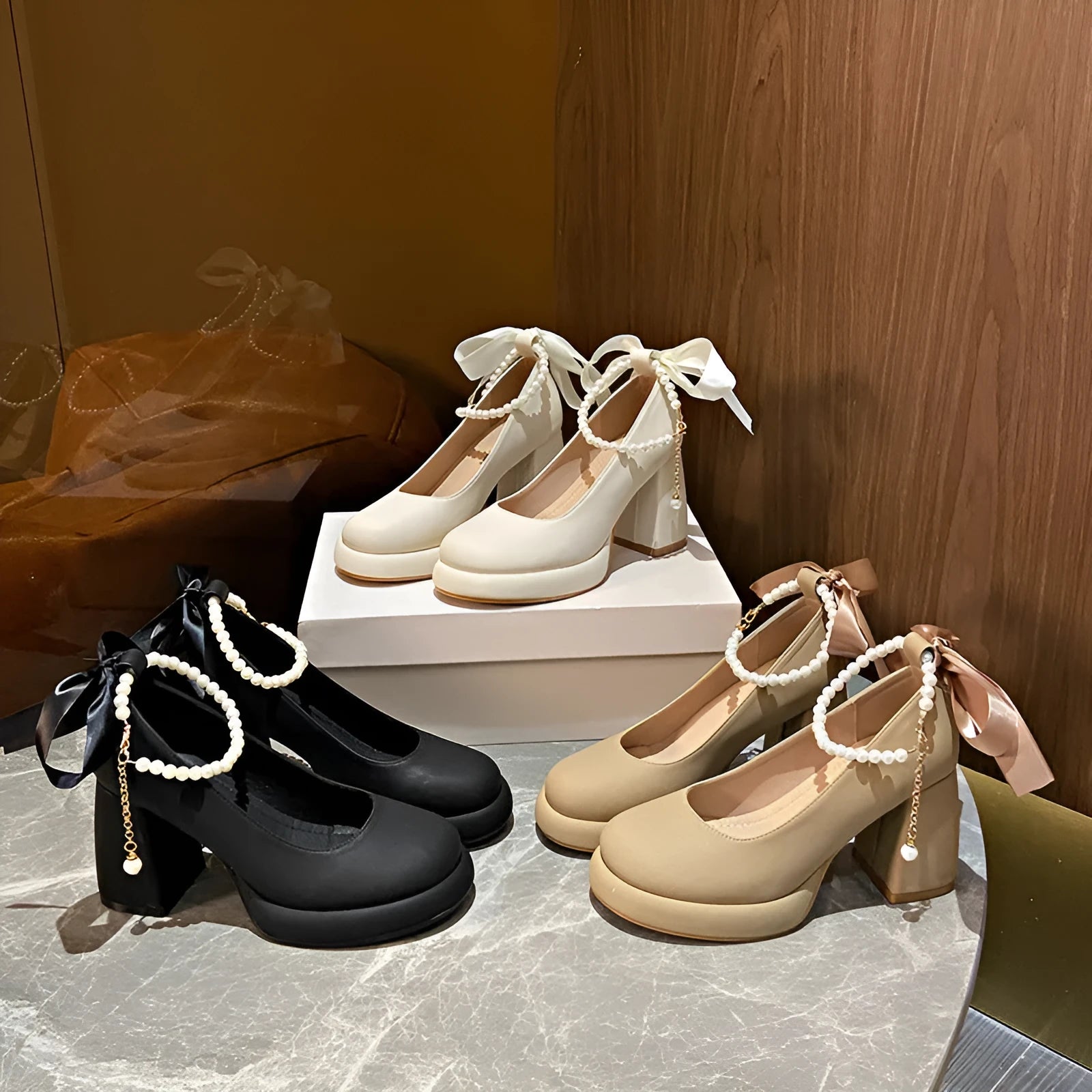 Women's beige Mary Jane shoes with chunky heel and ankle-strap buckle on a neutral background