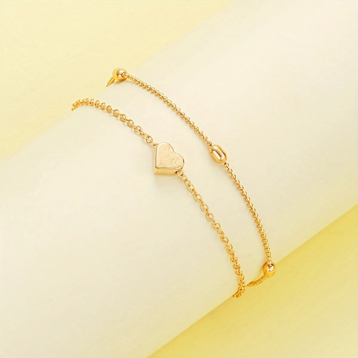 Double-layer stacked gold pearl heart necklace and bracelet jewelry set on display