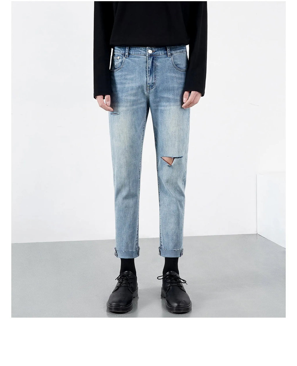Men's light blue ripped jeans with microelastic cotton blend fabric, shown flat for size reference