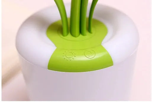 Modern rechargeable LED table lamp in blue with stylised plant shape on end table