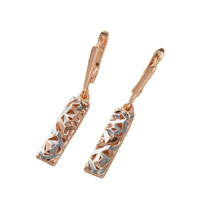 A pair of rectangular two-tone hollow stud earrings with a geometric design and electroplated alloy finish.