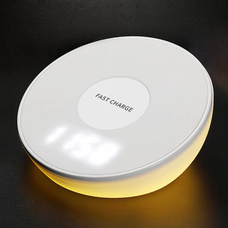 White wireless charger with digital clock display showing time and charging smartphone