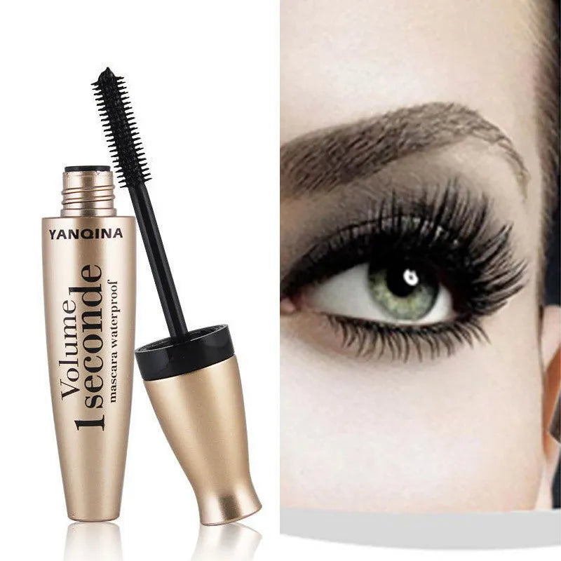 Gold tube black mascara in a vertical orientation against a light background