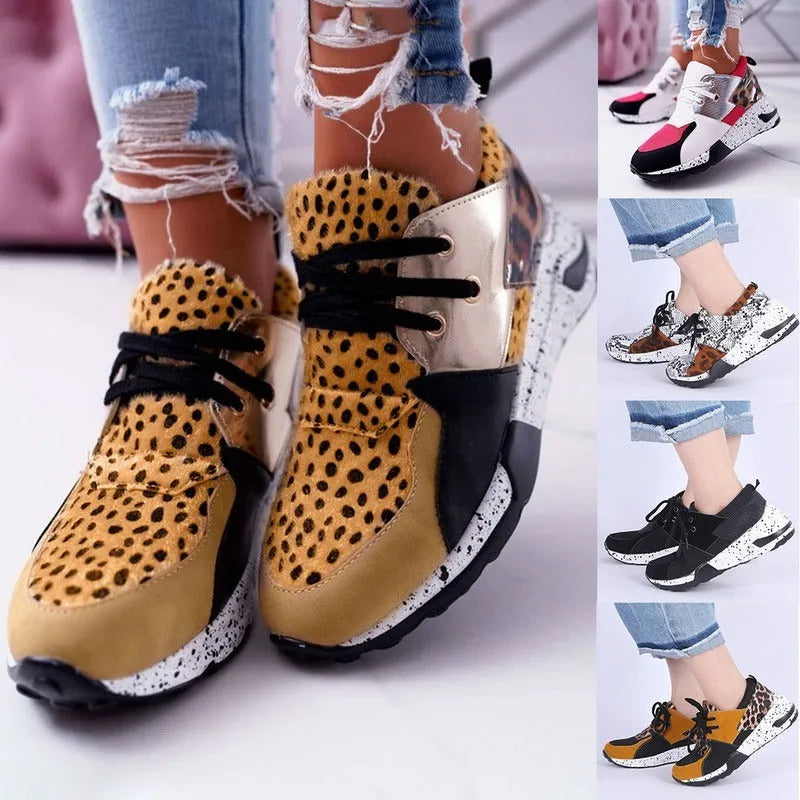 Women's black suede casual sneakers with a wedge heel and round toe on a white background.
