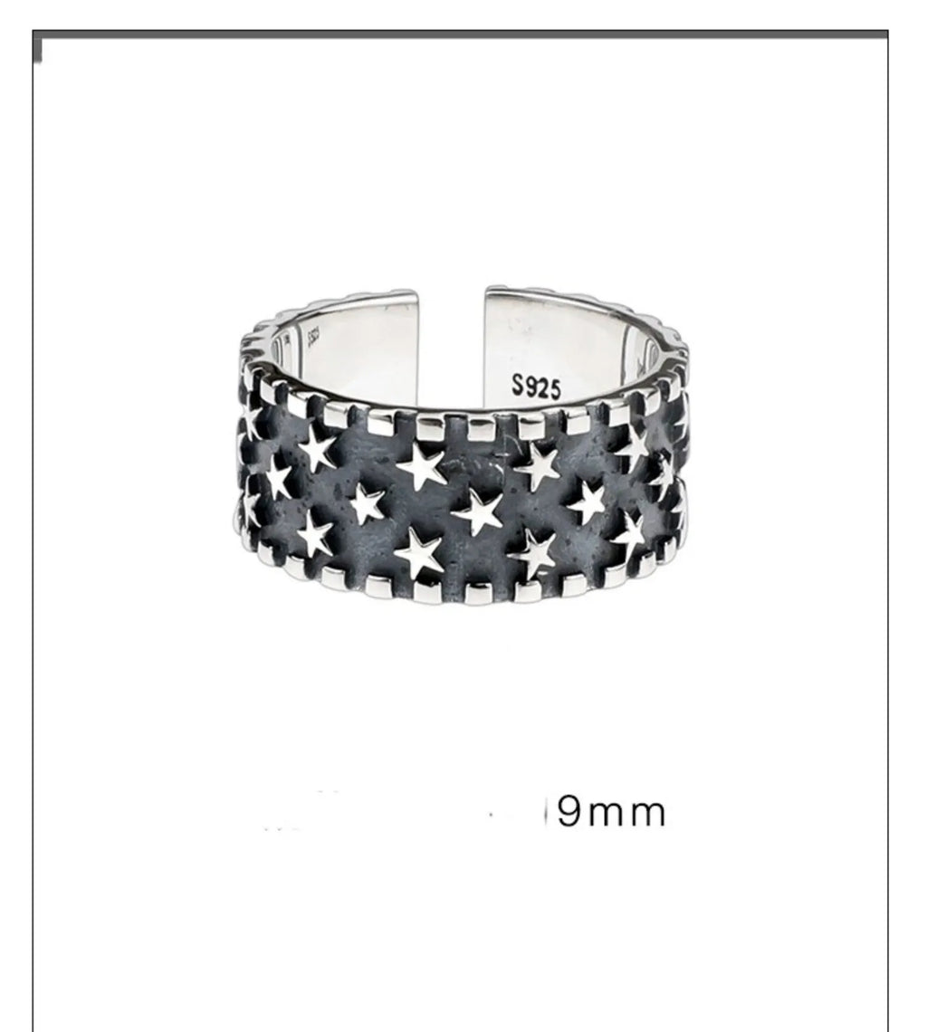 Adjustable sterling silver ring featuring a raised five-pointed star geometric pattern on the band.