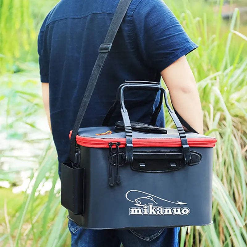 Collapsible EVA portable fishing bag in black with nylon zipper, folded flat on a wooden table