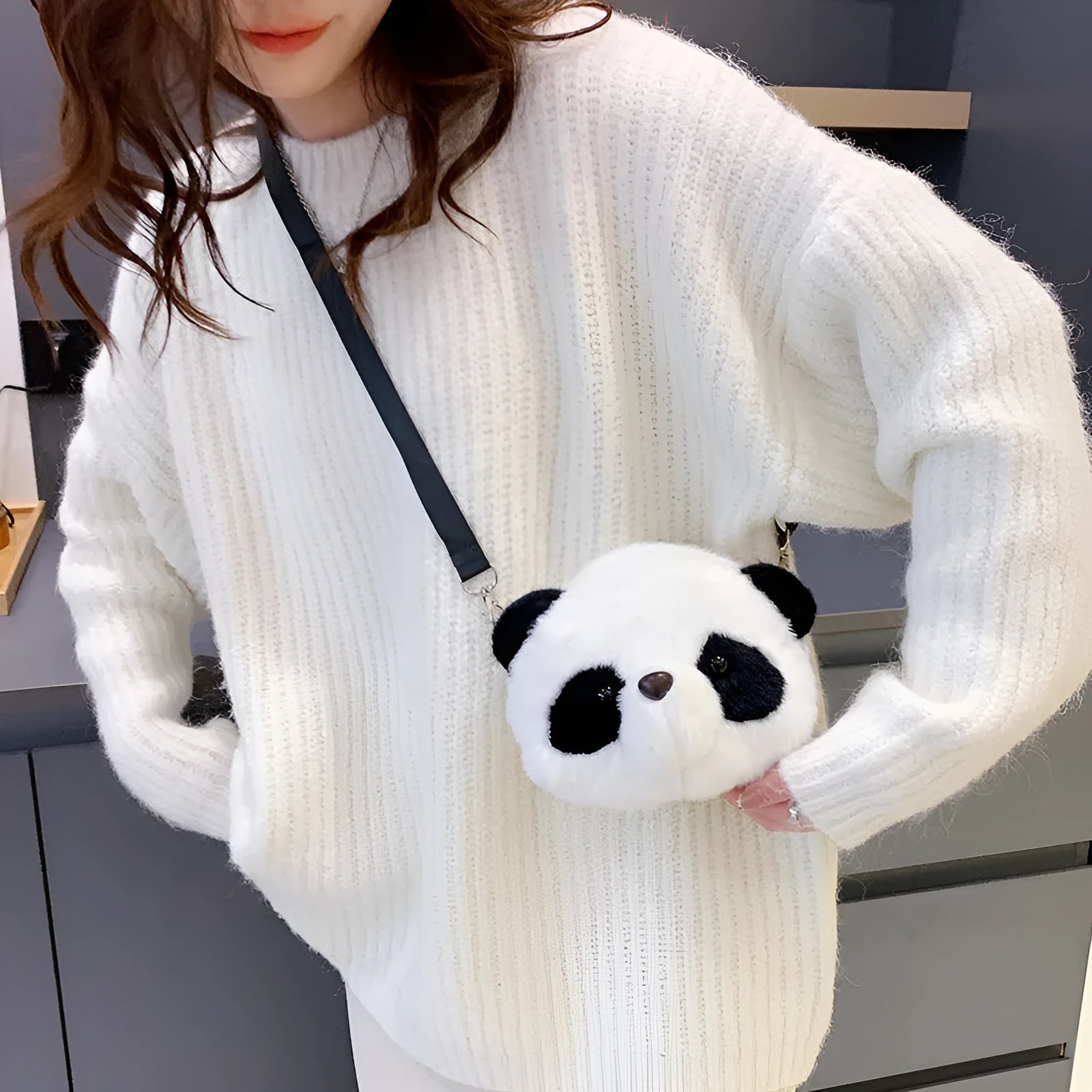 Soft plush crossbody bag with panda head design, cylindrical shape, and sandwich pocket