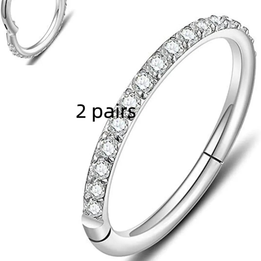 Two pairs of round, seamless 316 stainless steel nose rings showing black, gold, rose gold, and steel colour finishes.