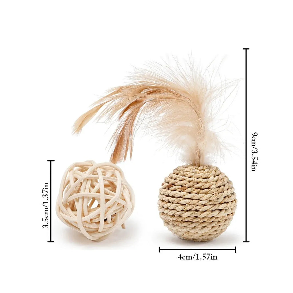 Two cat toys: a faux feather bell ball and a hollow rattan ball on a plain background.