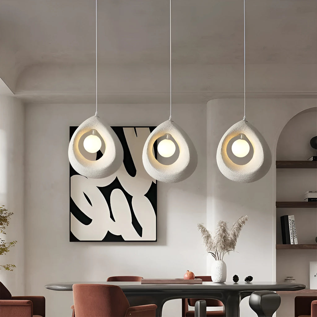Modern pendant ceiling light with a wide milky white glass shade in a retro chandelier style.