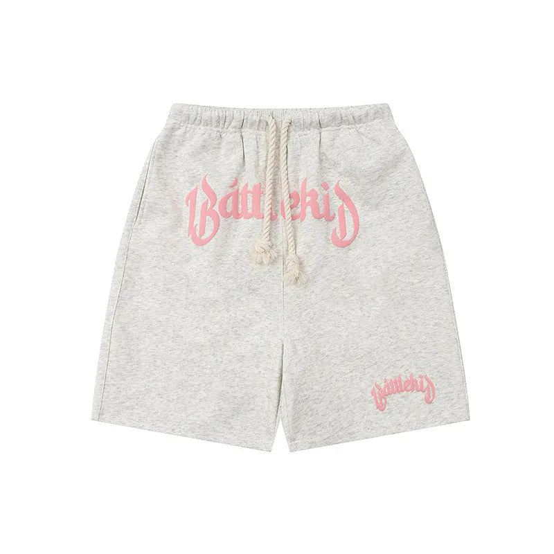 Men's loose grey cotton blend hip hop shorts with a cropped, street-style design on a neutral background.